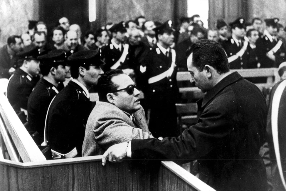 Лучано Леджо, босс сицилийской мафии, беседует с адвокатом в зале суда, 1969 год