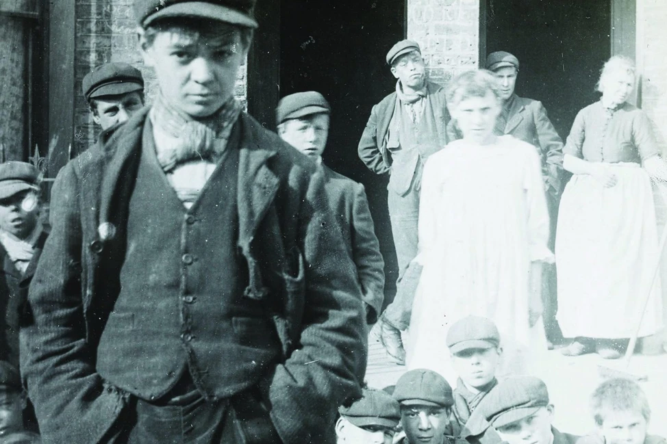 Группа подростков и молодых людей в кепках, характерная одежда рабочего класса около 1900 года